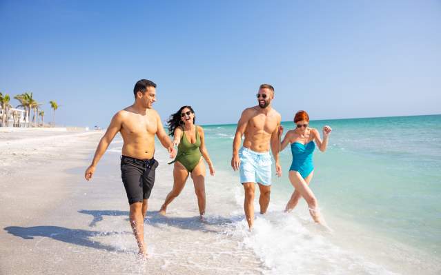 Two couples walking the beach in Punta Gorda/Englewood Beach