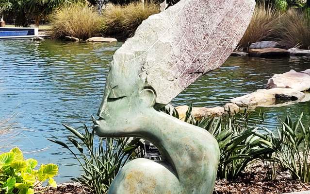 Zimsculpt sculpture next to koi pond at Peace River Botanical & Sculpture Gardens