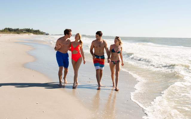 Two couples walking on beach at Don Pedro Island State Park