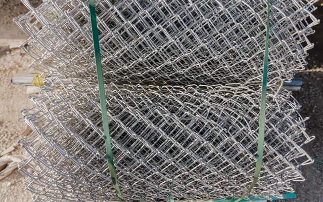Rolls of chain link fence made by Southern Bleacher Co.