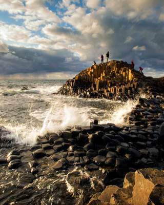 A couple in the distance standing on the Giant's Causeway.