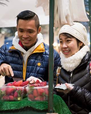 International visitors sampling the fruit stalls at St George's Market.