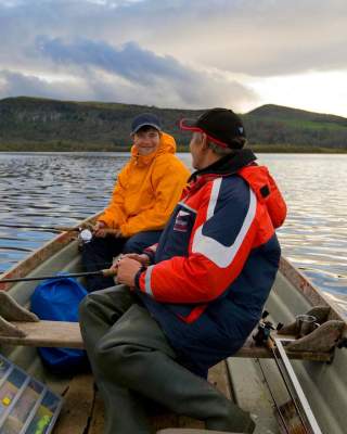 Father and son fishing on a row boat on Lough Macnean in Fermanagh
