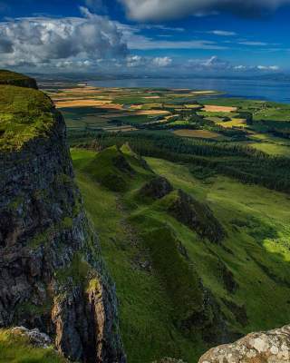 Top of Binevenagh over looking green farmland with Donegal in the distance