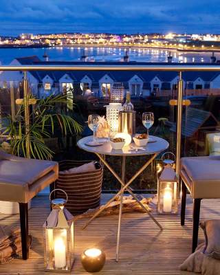beautiful night time view from the Blackrock House B&B. Candle lit table and two chairs for an evening drink