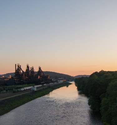 The sun sets over the Lehigh River and SteelStacks in Bethlehem, Pa