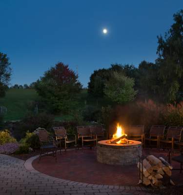 A firepit burns at night at Glasbern Inn