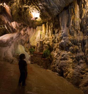 A child explores an underground Cavern.