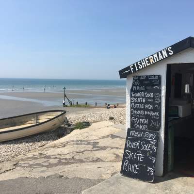 a view of east wittering beach with seafood hut