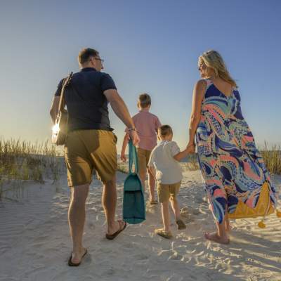A family walks down to the beach