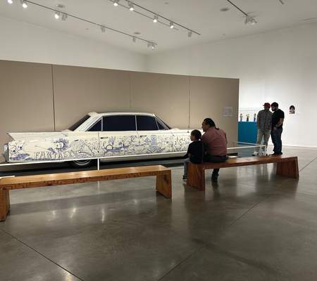 Visitors view a lowrider car at the National Hispanic Cultural Center