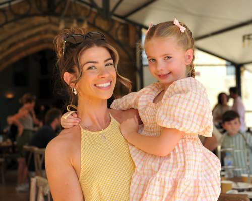 Mother holding her child in her arms, both smiling