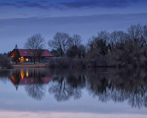 Log cabin by a lake at Loghouse Holidays