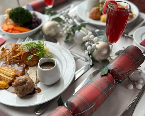 christmas dinner on a a plate and a christmas carcker