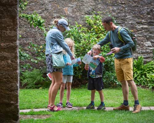 A family exploring the garden in summer at Compton Castle, Devon | James Dobson