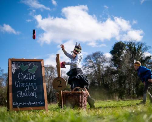 children on a sunny day tossing a welly