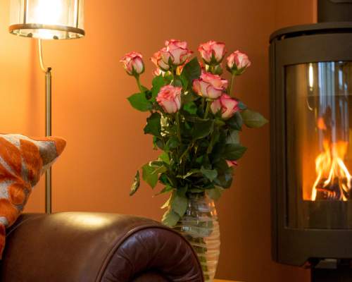 A cosy corner of a cottage with a warming log burner