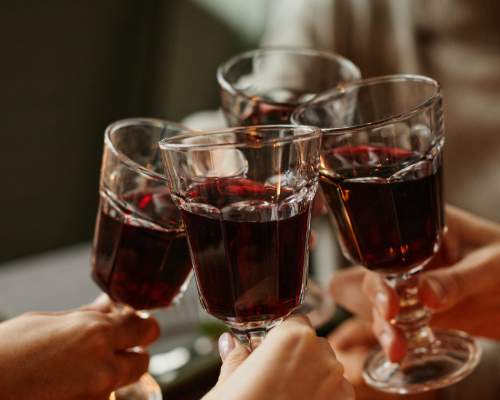 A group of people cheersing drinks