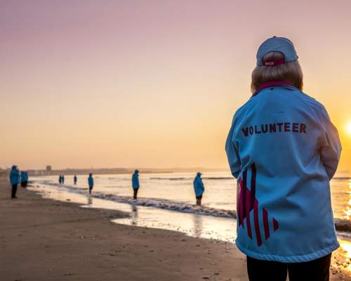 HEY volunteers standing on Bridlington beach on the shoreline