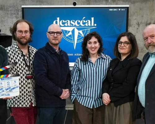 Representatives from Screen Kerry, Cork and Waterford, 4 men and 2 ladies photographed infront of a large screen with the Deasceal logo.