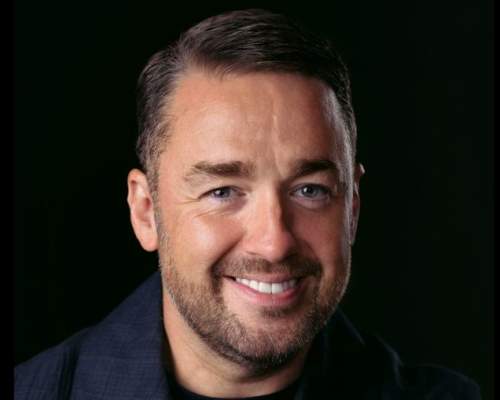 Jason Manford, comedian, against a black backdrop