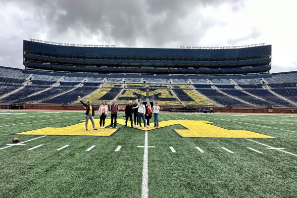 Group of people on field at Michigan Stadium