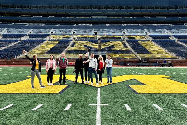 Tour group standing on field of Michigan Stadium