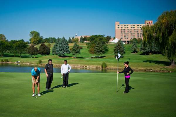 4 golfers on the green at golf course