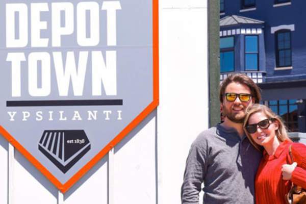 Couple by Historic Depot Town sign