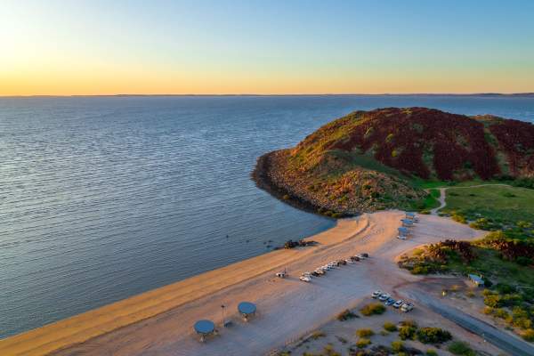Cars parked at Hearson Cove in Murujuga National Park, the Pilbara