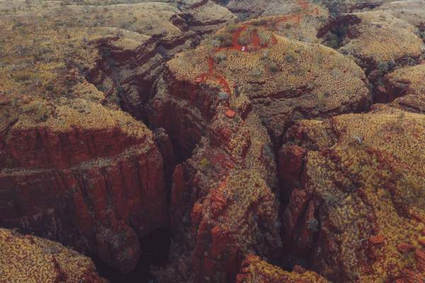 An aerial view of Oxer Lookout, looking back from the gorges towards the viewing platform. The platform overlooks 4 gorges, and in the image deeply carved gorges can be seen with the glimpse of water at the base of one.