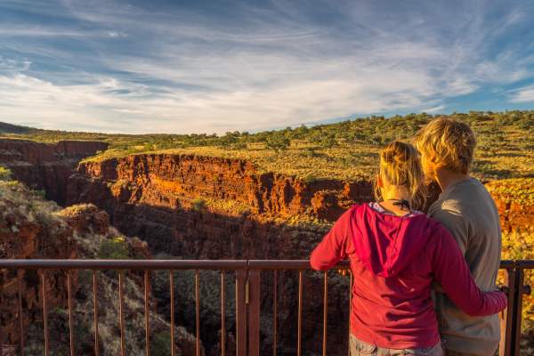 Two people standing at the Oxer Lookout, looking across Weano, Red, Hancock, and Joffre Gorges