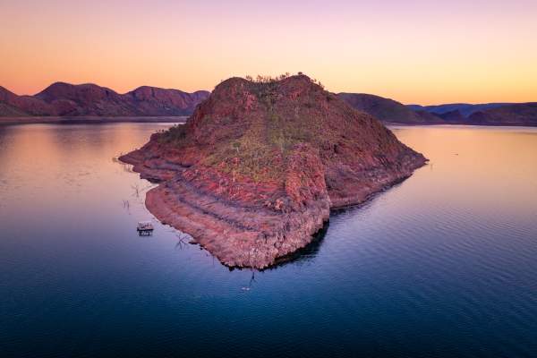 View of an island in Lake Argyle with a boat moored alongside.