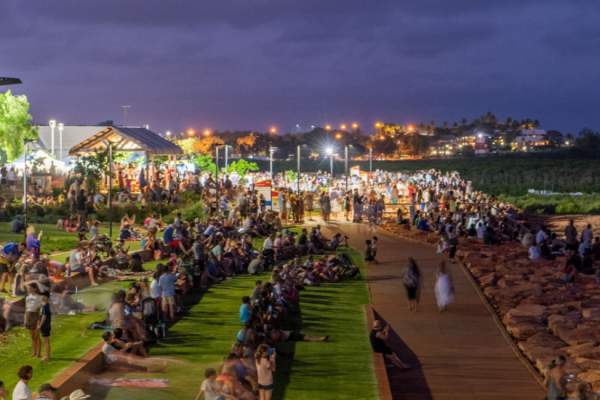 People gathered along the Staircase to the Moon viewing terrace at Town Beach Broome with the night markets in the background