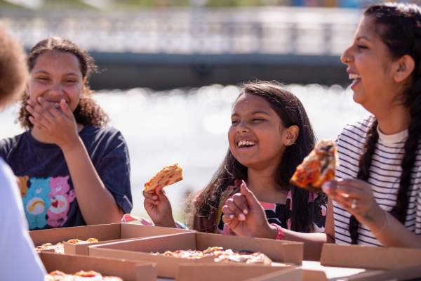 A family eating pizza at The Wave inland surfing lake near Bristol - credit The Wave