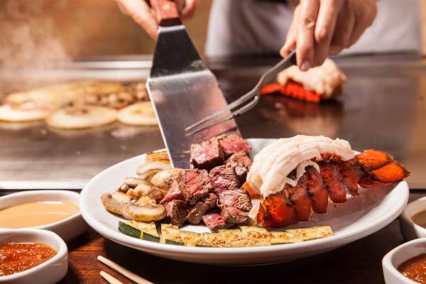 Hibachi style steak and lobster being served.