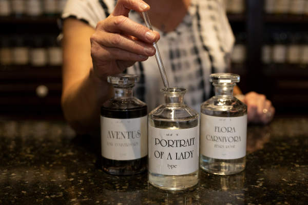 Person sampling a fragrance from a bottle