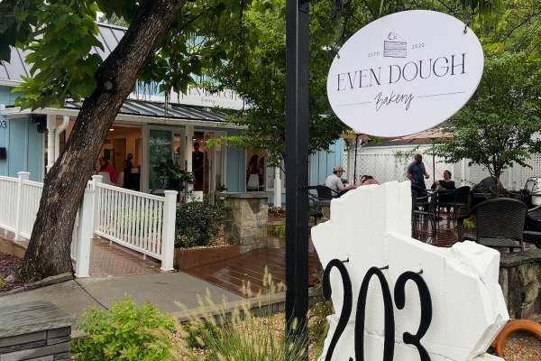 Sign for Even Dough Bakery in front of building