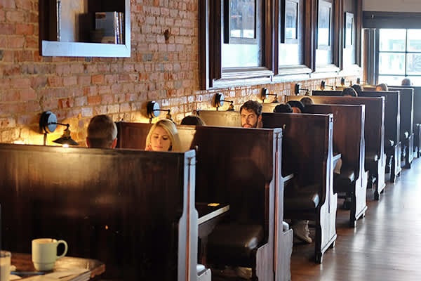 People sitting in booths at the Carolina Coffee Shop in Chapel Hill