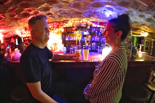 Two people sitting at the bar at The Cave nightlife venue