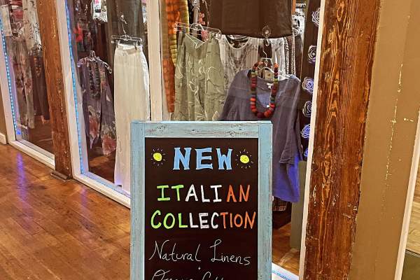 Sign that reads New Italian Collection in front of boutique store