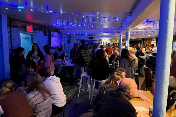 People gathered inside a local bar