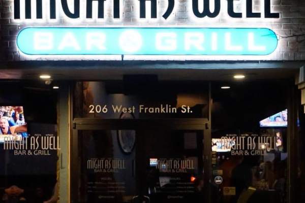 Outside view of Might as Well bar at night time