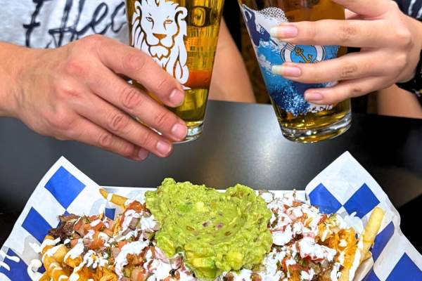 People clinking glasses and enjoying an appetizer