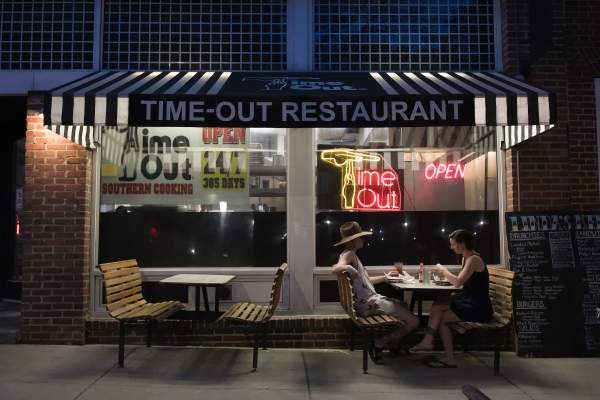 Two people dining outside a restaurant