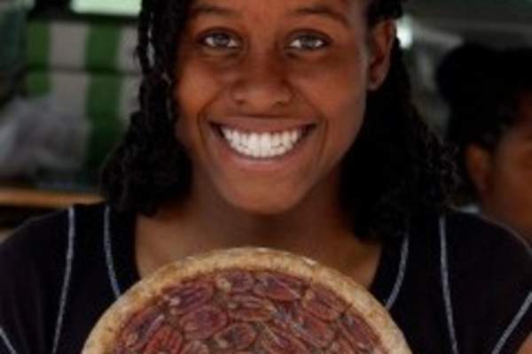 Girl with smile holding pie