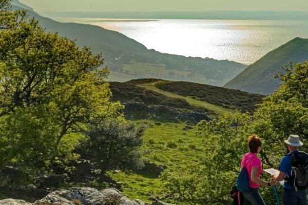 View of two walkers looking out over Sychnant Pass