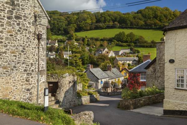 A street in Branscombe surrounded by fields and blue sky