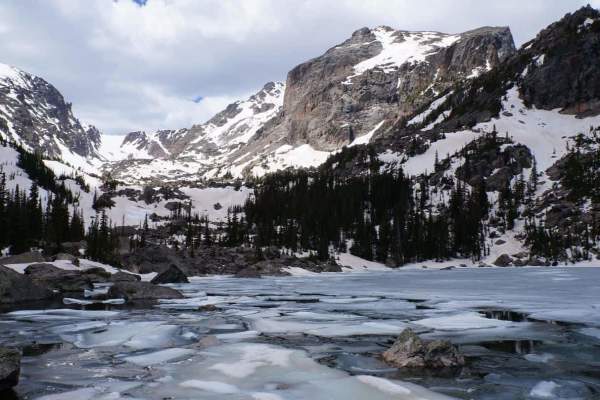 Frozen lake with snowy mountains