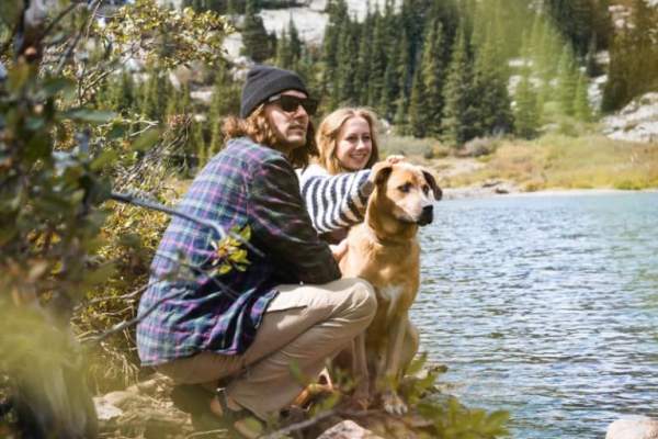 hikers and dog near water